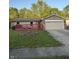 Charming single-story home with brick accents, red deck, a well-kept lawn, and an attached garage at 7627 Venetian Way, Indianapolis, IN 46217