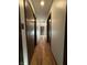 Hallway with hardwood floors and doors on either side at 7627 Venetian Way, Indianapolis, IN 46217