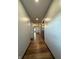 Hallway with hardwood-look flooring, recessed lighting, and doors along the length of the hall at 7627 Venetian Way, Indianapolis, IN 46217