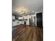 Modern kitchen with stainless steel appliances and white cabinetry, complete with wood-look flooring at 7627 Venetian Way, Indianapolis, IN 46217