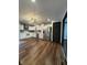 Contemporary kitchen with white cabinets, stainless steel appliances, and wood-look flooring at 7627 Venetian Way, Indianapolis, IN 46217
