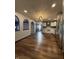 Kitchen with stainless steel appliances and adjacent to living room with wood floors at 7627 Venetian Way, Indianapolis, IN 46217