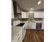Kitchen area with white cabinets, tile backsplash, and stainless steel appliances at 7627 Venetian Way, Indianapolis, IN 46217