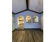 Living room with vaulted ceilings, wood floors, and arched openings leading to kitchen at 7627 Venetian Way, Indianapolis, IN 46217