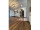 Open-concept living room showcasing arched doorways, wood flooring, and recessed lighting at 7627 Venetian Way, Indianapolis, IN 46217
