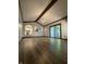 Living room with vaulted ceiling, modern lighting, wood floors, arched openings and sliding doors at 7627 Venetian Way, Indianapolis, IN 46217