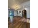 Open-concept living room featuring arched doorways, wood floors, and natural light at 7627 Venetian Way, Indianapolis, IN 46217