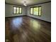Bright living room with wood floors, dual windows, and classic trim at 7627 Venetian Way, Indianapolis, IN 46217