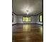 Bright living room with dark wood trim, hardwood floors, and large windows at 7627 Venetian Way, Indianapolis, IN 46217