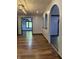 Open living area with arched doorways, recessed lighting, and wood flooring at 7627 Venetian Way, Indianapolis, IN 46217