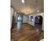 Open concept kitchen and dining area with wood floors and stainless steel appliances at 7627 Venetian Way, Indianapolis, IN 46217