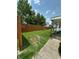 View of the backyard with partial fence and covered patio offering outdoor privacy and relaxation space at 803 W 12Th St, Anderson, IN 46016