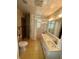 Retro bathroom with pink tub, patterned tile, and large mirror at 803 W 12Th St, Anderson, IN 46016