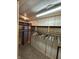 Walk-in closet with wooden paneling, built-in shelves, and hanging rod with hangers at 803 W 12Th St, Anderson, IN 46016