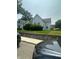 Charming front exterior showcasing white siding, neatly trimmed hedges, and an inviting curb appeal at 803 W 12Th St, Anderson, IN 46016