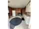 Bright kitchen featuring white cabinets, wood paneling, vinyl floors and appliances at 803 W 12Th St, Anderson, IN 46016