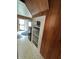 Galley kitchen with wood paneling, white cabinets, and appliances at 803 W 12Th St, Anderson, IN 46016