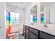 Modern bathroom features a double sink vanity and rainbow colored shower curtain at 830 Black Rock Cir, Lebanon, IN 46052