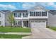 Two story home showcasing a well-manicured lawn and a gray and white exterior at 830 Black Rock Cir, Lebanon, IN 46052
