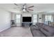 Spacious living room with a large grey couch, fan, and carpet flooring at 830 Black Rock Cir, Lebanon, IN 46052