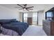 Bright main bedroom with a ceiling fan, dresser, and abundant natural light at 830 Black Rock Cir, Lebanon, IN 46052