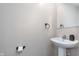 Clean powder room featuring a pedestal sink, dark accents, and modern fixtures at 830 Black Rock Cir, Lebanon, IN 46052