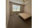 Bedroom with neutral color palette, carpet, window with blinds, and door at 8306 Hunters Meadow Way, Indianapolis, IN 46259