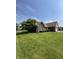 Single-Gathering home featuring brick exterior, a well-maintained lawn, and mature trees on a sunny day at 8306 Hunters Meadow Way, Indianapolis, IN 46259