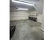 Spacious garage featuring ample shelving, workbench, and concrete floor at 8306 Hunters Meadow Way, Indianapolis, IN 46259