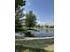 Scenic pond with a tranquil fountain, surrounded by lush greenery and decorative rock borders at 8306 Hunters Meadow Way, Indianapolis, IN 46259