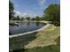 Scenic community pond with fountain, rock edging, and lush green surroundings at 8306 Hunters Meadow Way, Indianapolis, IN 46259