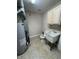 Utility room including water heater, toilet, and utility sink at 8306 Hunters Meadow Way, Indianapolis, IN 46259