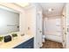This bathroom features a single sink, cabinet storage, tub and shower combo and bright lighting at 8980 Cinnebar Dr, Indianapolis, IN 46268