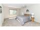 Bedroom with carpet, ceiling fan, a large window, and neutral decor for a peaceful retreat at 8980 Cinnebar Dr, Indianapolis, IN 46268