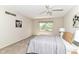 Bedroom with carpet, a ceiling fan, a large window, and neutral decor for a peaceful retreat at 8980 Cinnebar Dr, Indianapolis, IN 46268