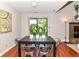 Dining area featuring a sliding glass door and a table with seating for four, wood flooring at 8980 Cinnebar Dr, Indianapolis, IN 46268