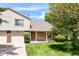 Charming two-story home with a brick and siding exterior, lush lawn, and a well-maintained front yard at 8980 Cinnebar Dr, Indianapolis, IN 46268