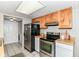 Bright kitchen features stainless steel appliances and white cabinets, open to a laundry area at 8980 Cinnebar Dr, Indianapolis, IN 46268