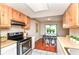 Updated kitchen is open to a bright dining area with hardwood floors and access to the backyard at 8980 Cinnebar Dr, Indianapolis, IN 46268
