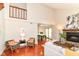 Bright living room featuring a fireplace, vaulted ceiling, wood floors, and ample seating at 8980 Cinnebar Dr, Indianapolis, IN 46268