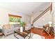 Bright living room with a staircase, wood floors, fireplace, and a neutral color palette at 8980 Cinnebar Dr, Indianapolis, IN 46268