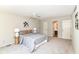 This primary bedroom features carpet floors, ceiling fan, ensuite bathroom, and neutral paint at 8980 Cinnebar Dr, Indianapolis, IN 46268