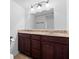 Bathroom boasts a dark wood vanity with marble countertops, and a decorative light fixture at 916 Ardsley Dr, Indianapolis, IN 46234