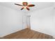 Bedroom featuring hardwood floors, ceiling fan, and open closet at 916 Ardsley Dr, Indianapolis, IN 46234