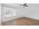 Bedroom featuring wood-look floors, a large window, ceiling fan, and neutral walls at 916 Ardsley Dr, Indianapolis, IN 46234