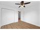 Bedroom featuring wood-look floors, ceiling fan, closet and neutral walls at 916 Ardsley Dr, Indianapolis, IN 46234