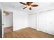 Bedroom with hardwood floors, ceiling fan, and double closets at 916 Ardsley Dr, Indianapolis, IN 46234