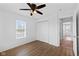 Bedroom featuring wood-look floors, closet, ceiling fan, and access to an adjoining room at 916 Ardsley Dr, Indianapolis, IN 46234