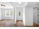 Inviting entryway with wood-look floors, white walls, and a decorative front door at 916 Ardsley Dr, Indianapolis, IN 46234