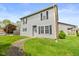 A charming home with manicured front yard, stone walkway, and a brick chimney on the side at 916 Ardsley Dr, Indianapolis, IN 46234